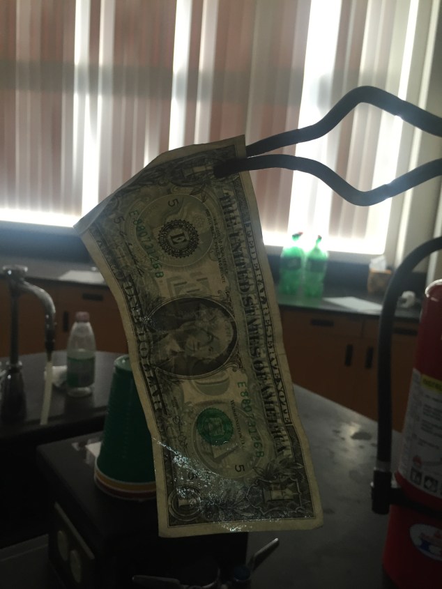 After the bill has been allowed to soak in the solution for a few minutes, remove it from the beaker and move the beaker away from the demo area (you do not want such a large source of fuel near an open flame!!). Keep the fire extinguisher handy, just in case!